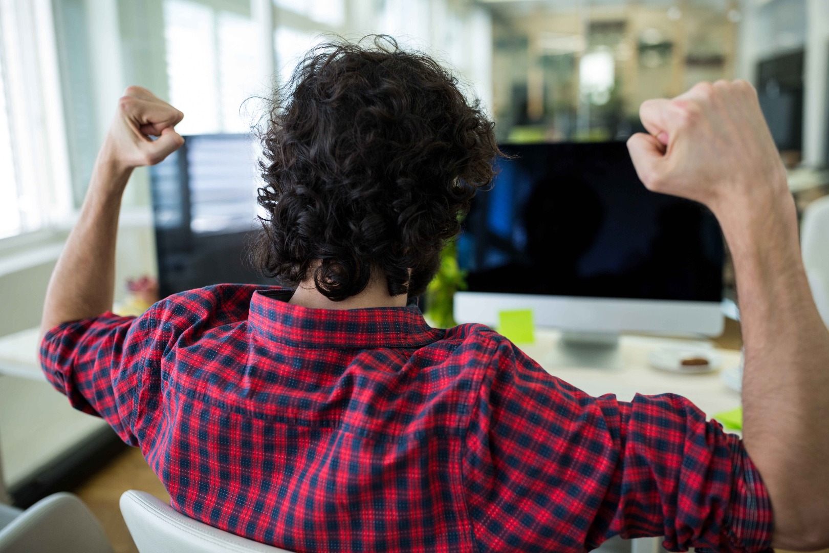 male-graphic-designer-cheering-office.jpg